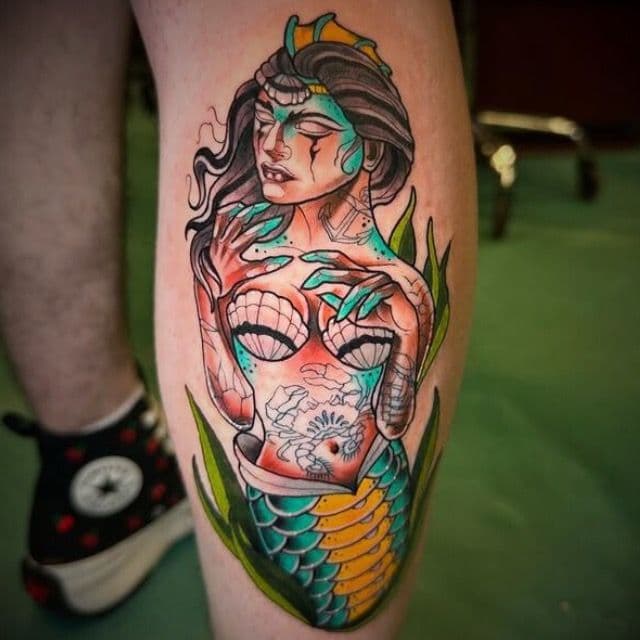 Colorful mermaid tattoo on the calf.